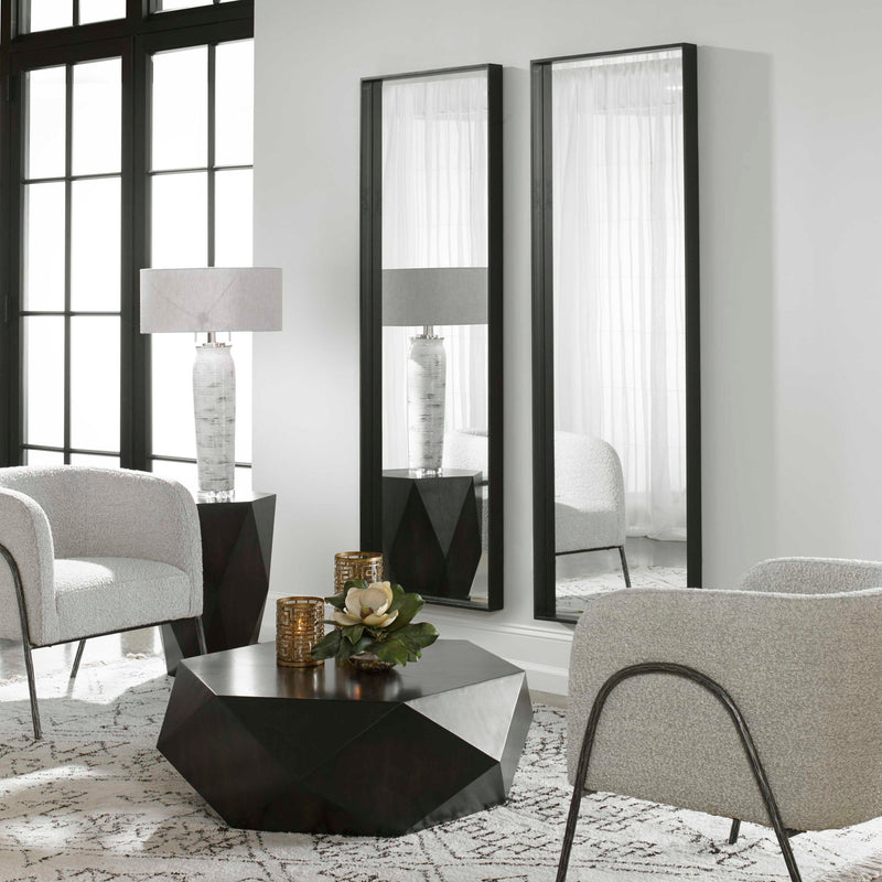 Uttermost Kahn oversized rectangular black accent mirror hanging on a wall, modern design with a sleek black frame.