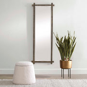 Uttermost Abanu ribbed dressing vanity mirror with a sleek, modern design reflecting light and showcasing its textured surface.
