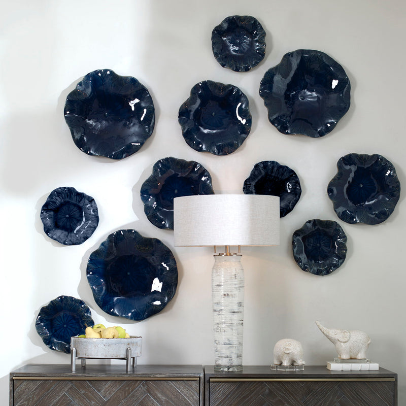 Set of three ceramic wall decor pieces by Uttermost featuring modern abstract designs for stylish wall decoration.