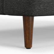 Livingston upholstered stationary sofa by Simpli-Home with plush fabric and cushioned backrest in a cozy living room setting.