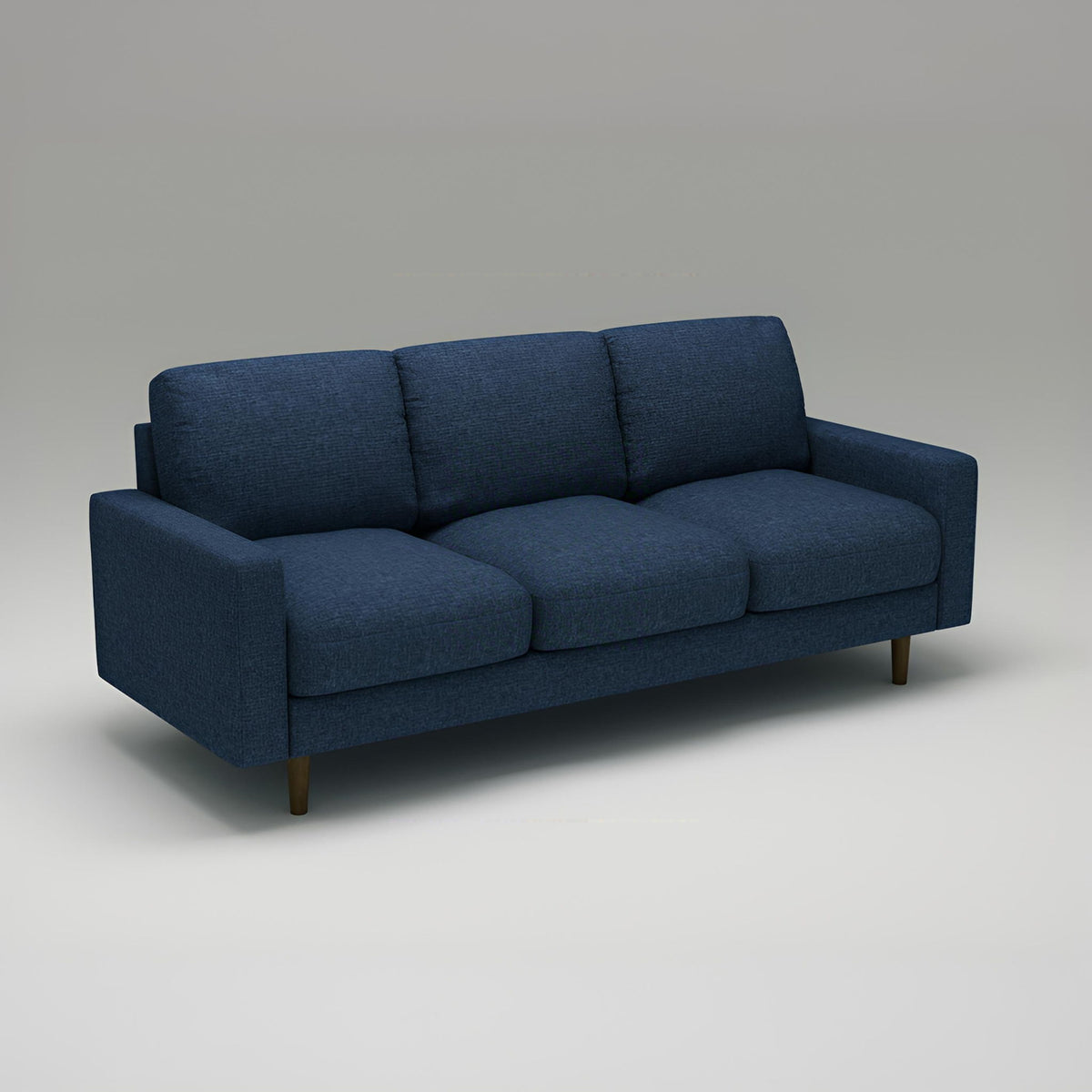 Dark blue US Pride 3-seater stationary sofa with loose back cushions and accent pillows for a stylish living room setting.