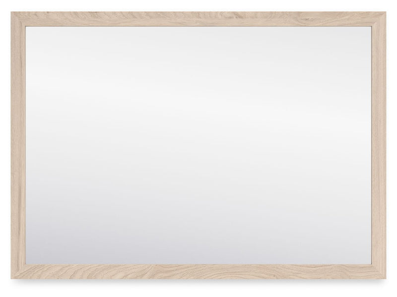 Signature Design by Ashley Cadmori bedroom mirror with a sleek rectangular frame, reflecting a modern bedroom decor.