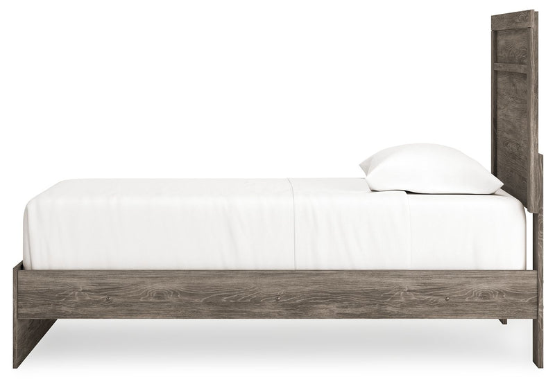 Signature Design by Ashley Ralinksi panel bed with a sleek wooden frame and modern design, shown in a cozy bedroom setting.