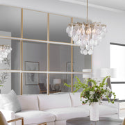 Uttermost Alexo square wall mirror with a sleek, modern frame hanging on a wall, reflecting a minimalist interior.