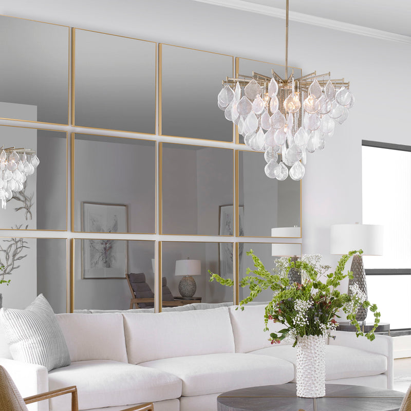 Uttermost Alexo square wall mirror with a sleek, modern frame hanging on a wall, reflecting a minimalist interior.