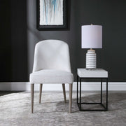 Pair of armless chairs from Uttermost's Brie chair set, featuring sleek design and neutral upholstery.