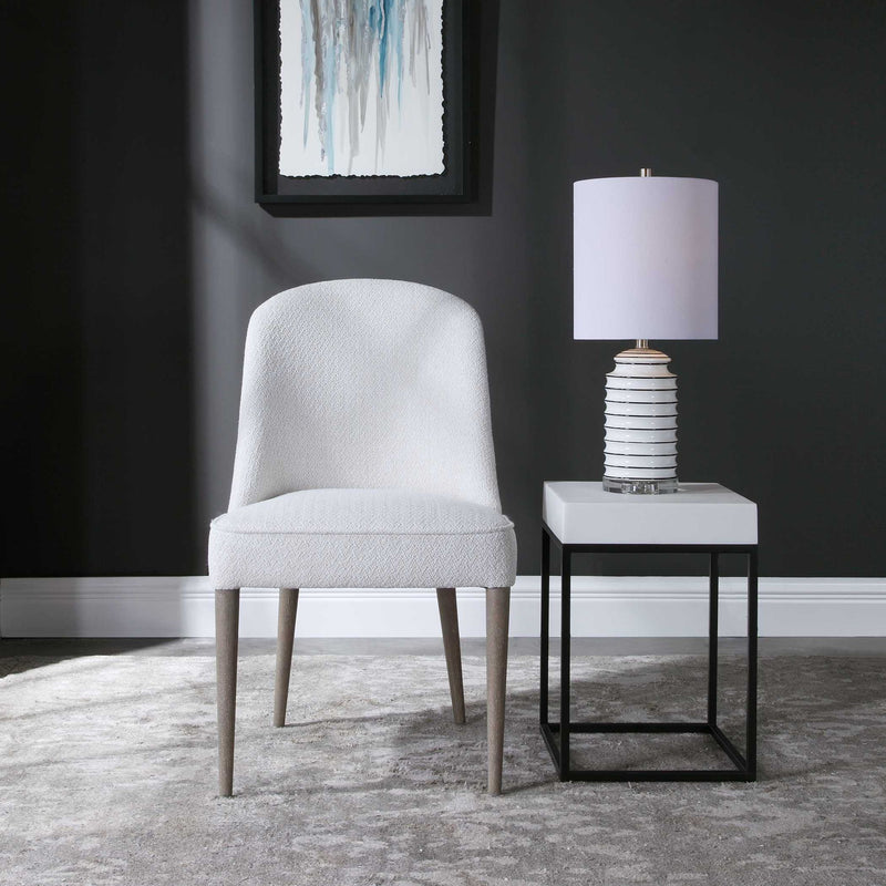 Pair of armless chairs from Uttermost's Brie chair set, featuring sleek design and neutral upholstery.