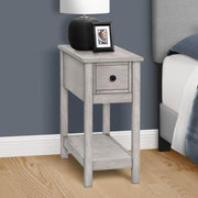 8th Street accent end table with two tiers, narrow design, storage drawer, and a lamp on top, showcasing its charming style.