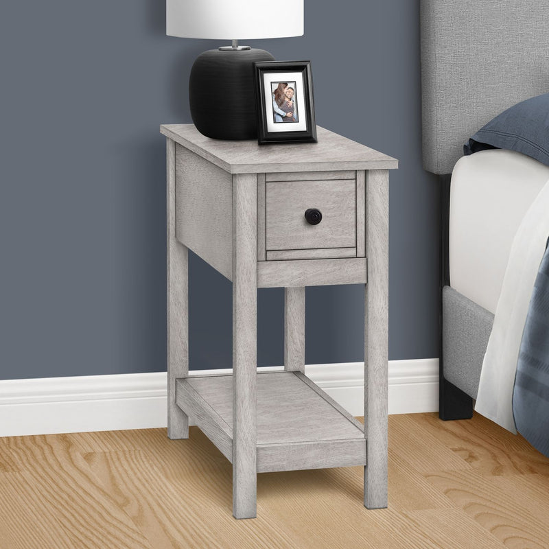 8th Street accent end table with two tiers, narrow design, storage drawer, and a lamp on top, showcasing its charming style.