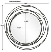 Uttermost Whirlwind round wall mirror with a sleek, modern frame hanging on a wall.
