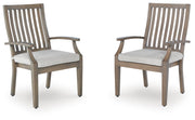 Set of two brown and beige Rainier Ranch arm chairs with cushions by Signature Design Ashley, showcasing stylish and comfortable seating.