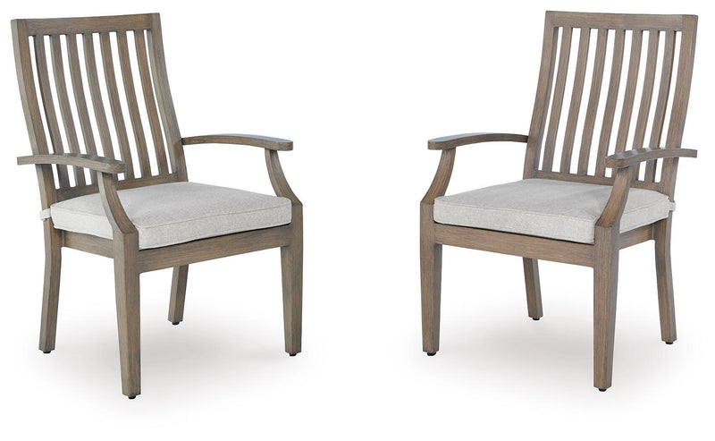 Set of two brown and beige Rainier Ranch arm chairs with cushions by Signature Design Ashley, showcasing stylish and comfortable seating.