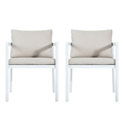 Set of two Noble House all-weather outdoor dining chairs with armrests and woven rattan design on a patio.