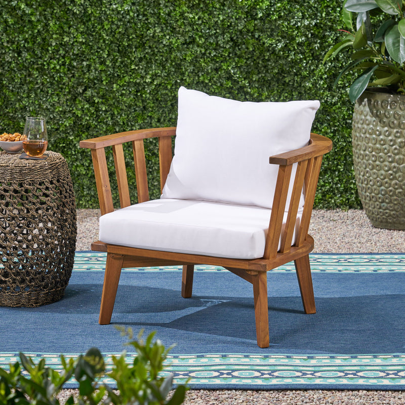 Noble House outdoor arm chair with curved backrest and white frame, designed for comfortable outdoor seating.