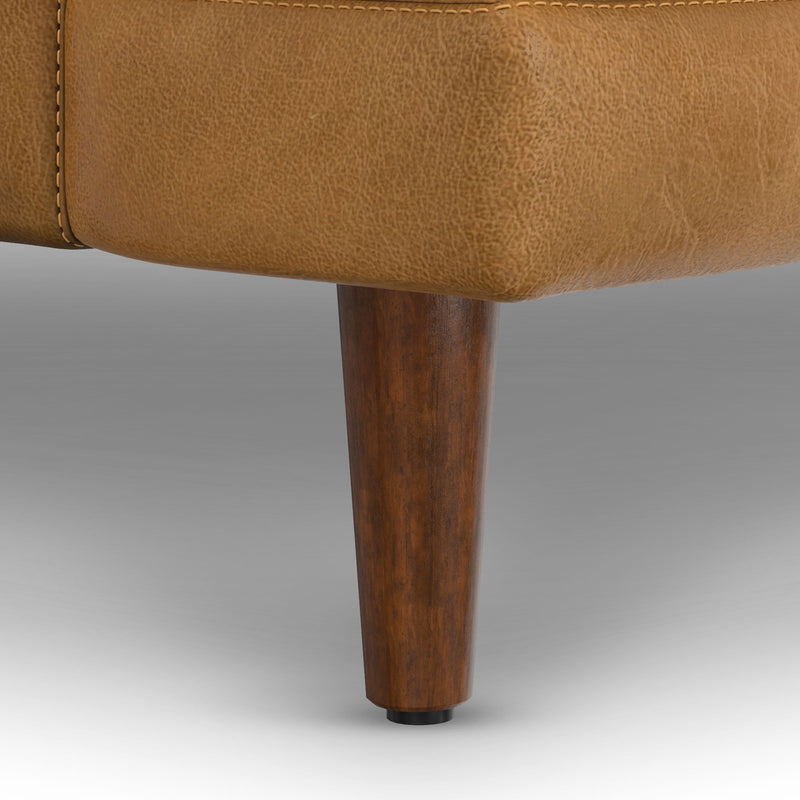 Livingston upholstered stationary sofa by Simpli-Home featuring plush fabric, cushioned backrest, and wooden legs.