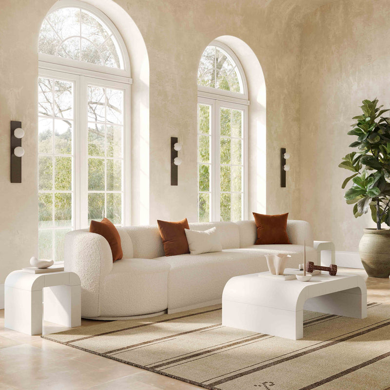 TOV Furniture Hump console table with a sleek, modern design featuring a smooth wooden surface and minimalist metal legs.