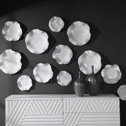 Set of three ceramic wall decor pieces by Uttermost, featuring modern abstract designs for stylish home decoration.