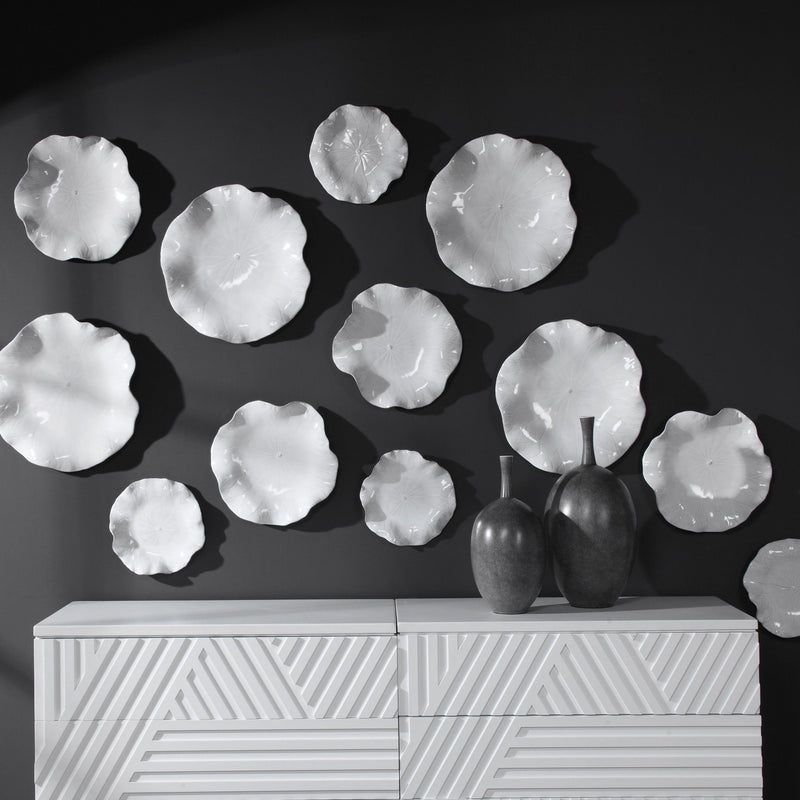 Set of three ceramic wall decor pieces by Uttermost, featuring modern abstract designs for stylish home decoration.