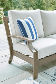 Brown and beige Rainier Ranch loveseat with cushion from Signature Design by Ashley, showcasing comfortable fabric upholstery.