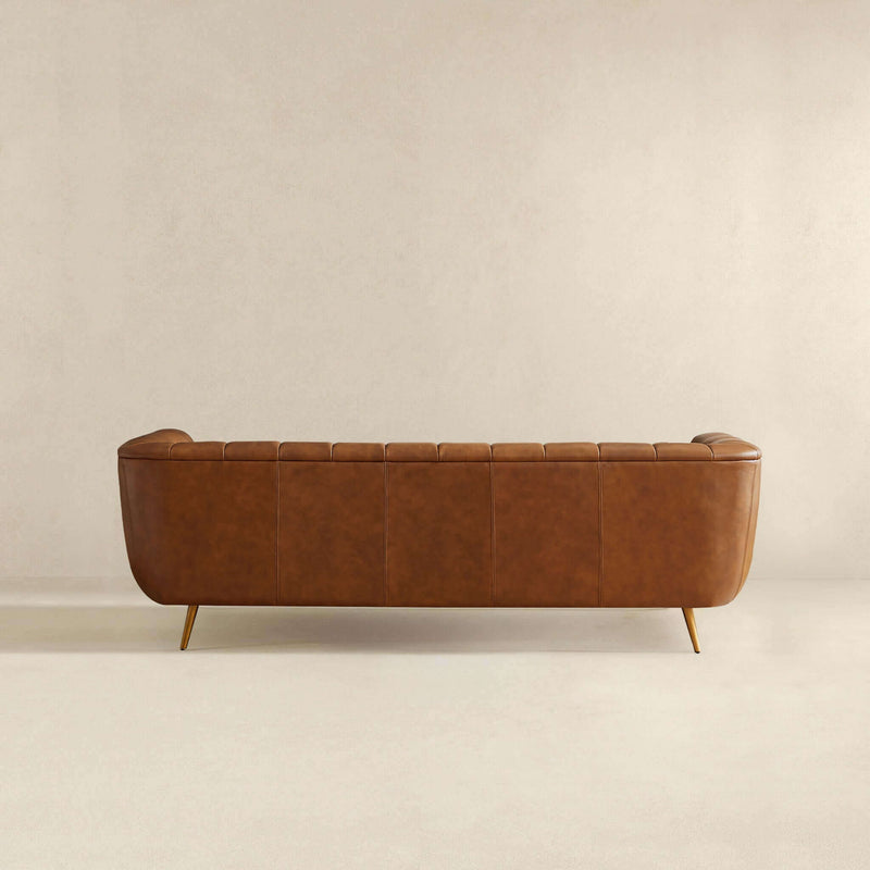 Ashcroft Furniture Ava gold and tan stationary sofa with plush cushions and modern design, shown in a stylish living room setting.