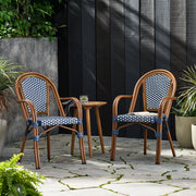 Set of two Noble House bistro chairs with white and navy two-toned checkered pattern, featuring wooden legs and cushioned seats.