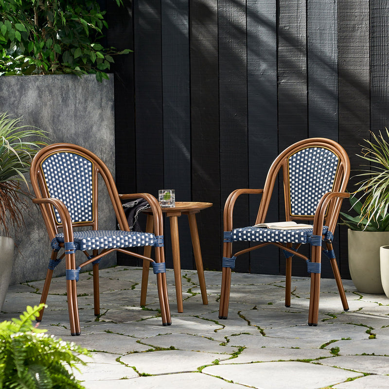 Set of two Noble House bistro chairs with white and navy two-toned checkered pattern, featuring wooden legs and cushioned seats.
