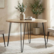 Natural wood Hunter round dining table by Simpli-Home with a smooth surface and sturdy legs, ideal for casual dining spaces.