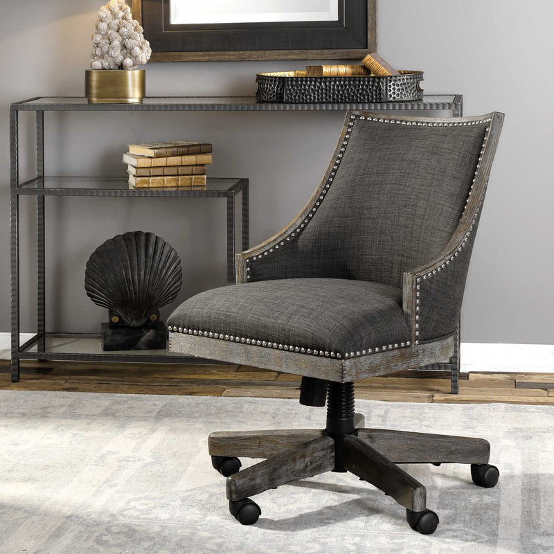 Aidrian charcoal desk chair by Uttermost featuring a modern design with a cushioned seat and backrest on sleek metal legs.