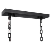 Uttermost Jarsdel 6-light black industrial island pendant light with metal shades hanging in a modern kitchen setting.