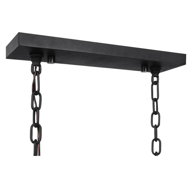Uttermost Jarsdel 6-light black industrial island pendant light with metal shades hanging in a modern kitchen setting.