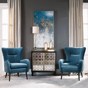 Blue Mid-Century Accent Chair by Uttermost featuring sleek wooden legs and a plush upholstered seat and back.