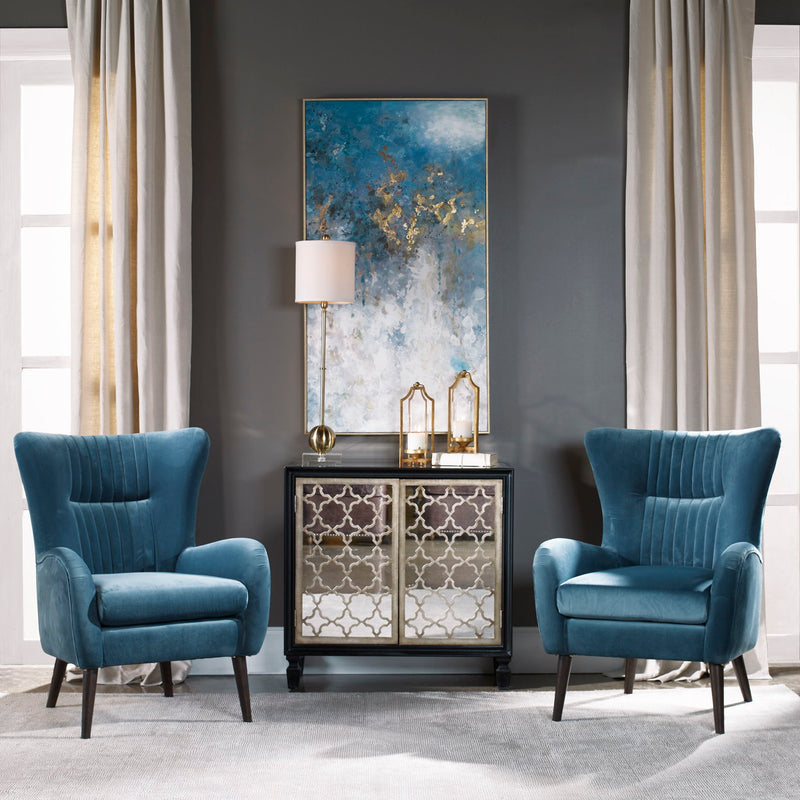 Blue Mid-Century Accent Chair by Uttermost featuring sleek wooden legs and a plush upholstered seat and back.