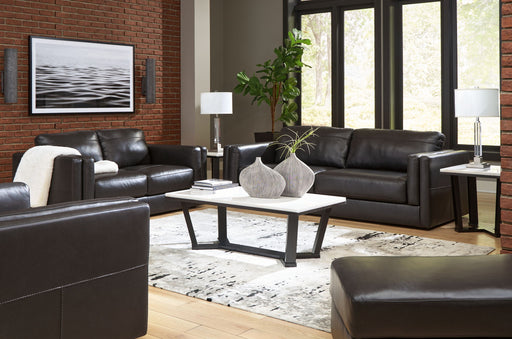 Signature Design by Ashley Amiata living room set with stationary chair and matching ottoman, featuring plush upholstery and modern design.
