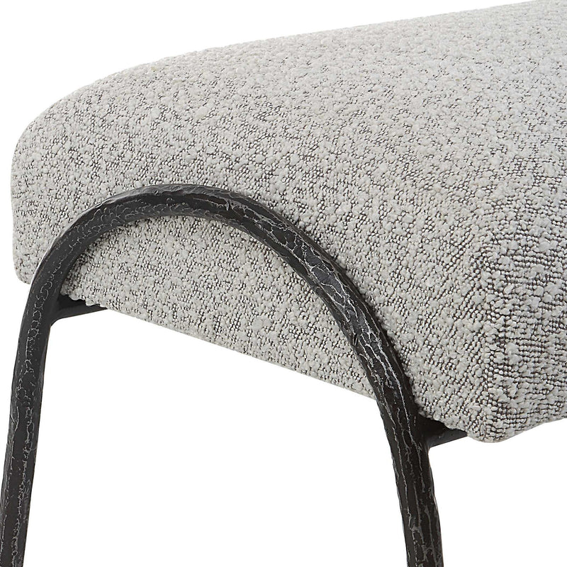 Gray upholstered Jacobsen modern bench by Uttermost with sleek, contemporary design and cushioned seating.