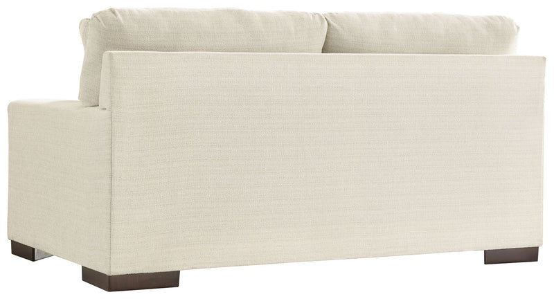 Signature Design by Ashley Maggie stationary loveseat with plush cushions and neutral fabric, perfect for cozy living room seating.