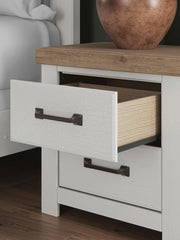Benchcraft white and brown two-drawer nightstand with charging station, modern design, featuring sleek drawers and a sturdy build.