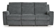 Signature Design by Ashley Barnsana Power Reclining Sofa with plush cushions and reclining features in a modern living room setting.