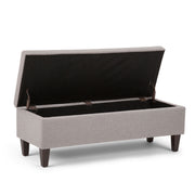 Simpli-Home Monroe upholstered storage ottoman with a cushioned top and fabric finish, ideal for living room storage and seating.