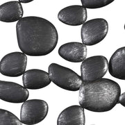 Uttermost black forged iron wall art featuring stacked skipping stones design for modern home decor.