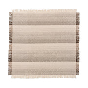 Soft beige Beryl blanket by Classic Home, draped over a cozy armchair, showcasing its plush fabric and warm texture.