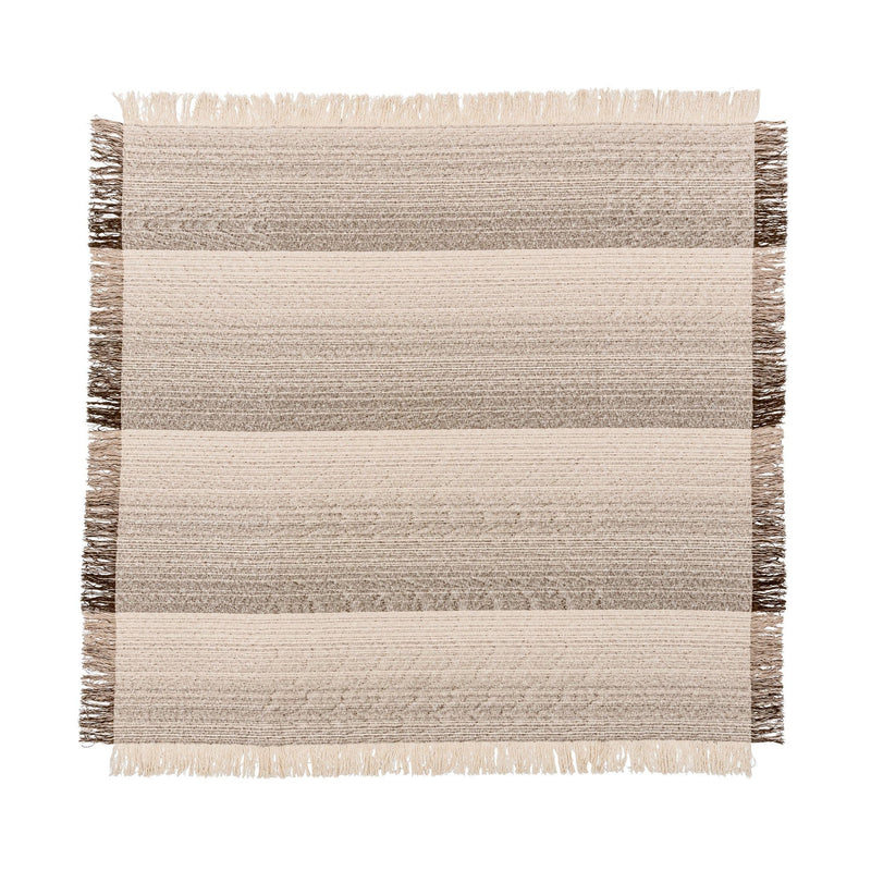 Soft beige Beryl blanket by Classic Home, draped over a cozy armchair, showcasing its plush fabric and warm texture.