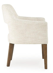 Set of two Benchcraft® Marxmore beige and brown upholstered dining arm chairs with padded seats and curved backrests.