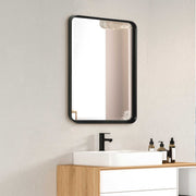 Black Croften vanity mirror by Uttermost featuring a sleek, modern design with a reflective glass surface.