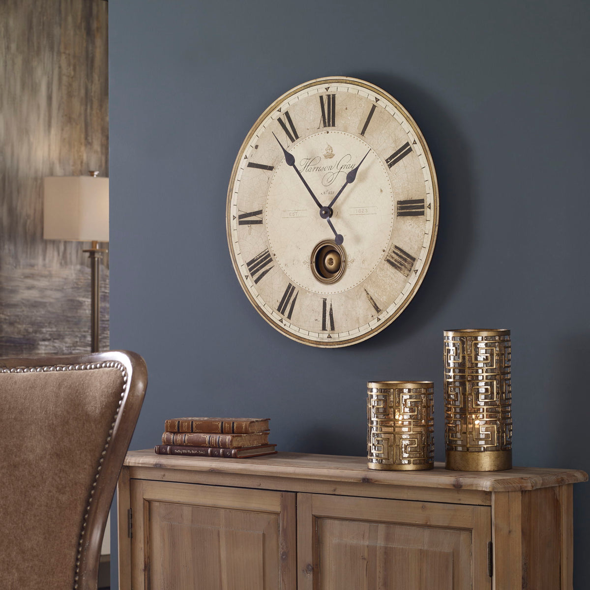 Uttermost Harrison Gray wall clock with a modern design and sleek gray finish, hanging on a wall.