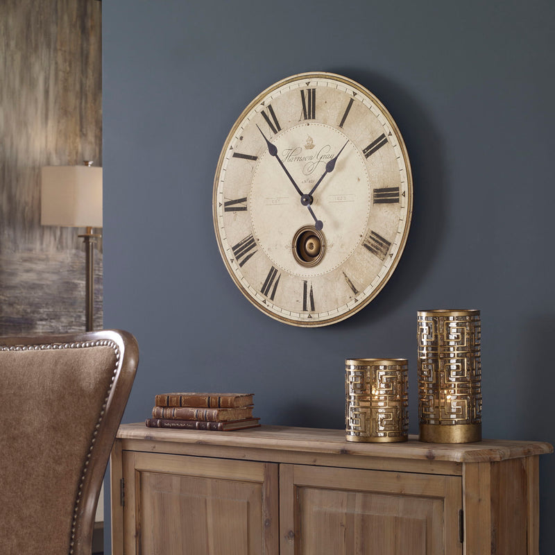 Uttermost Harrison Gray wall clock with a modern design and sleek gray finish, hanging on a wall.