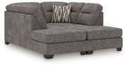 Benchcraft Olten stationary sectional sofa with plush cushions and modern design, shown in a cozy living room setting.