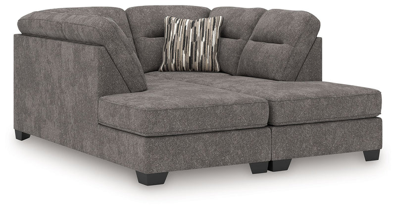 Benchcraft Olten stationary sectional sofa with plush cushions and modern design, shown in a cozy living room setting.
