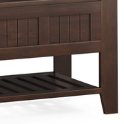 Brown Acadian Entryway Storage Bench with shelf by Simpli-Home, featuring a sturdy wooden design and convenient storage space.