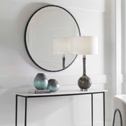 Round black wall mirror by Uttermost with a sleek, modern frame, perfect for contemporary home decor.