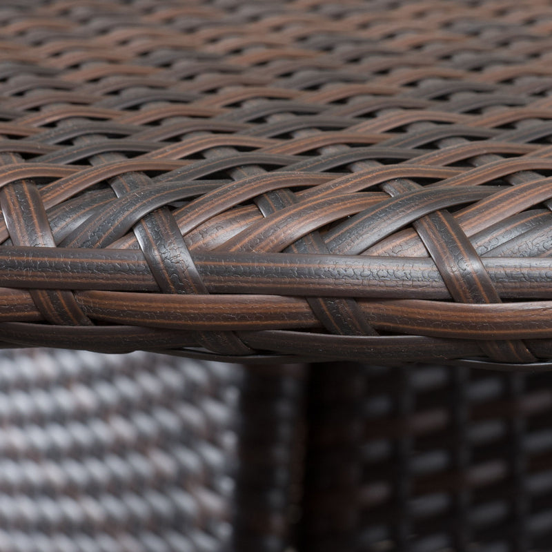 Noble House Corsica round dining table with a brown finish, showcasing smooth surface and sturdy wooden legs.